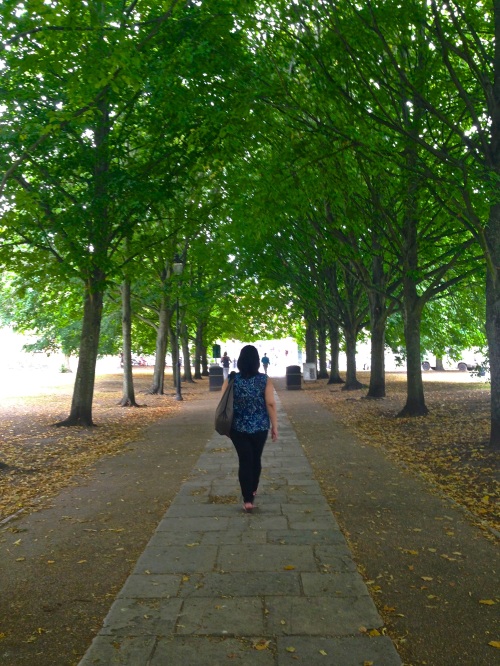 The sestra walking dramatically down the tree-lined path. (iPhone 5)